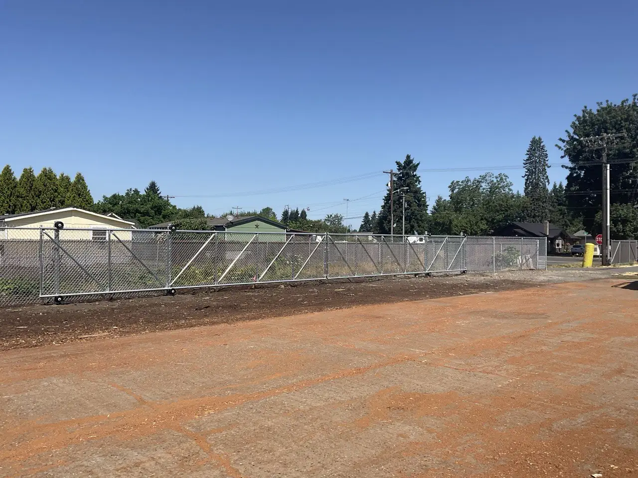 Commercial chain link fence with double swing gates at a business property